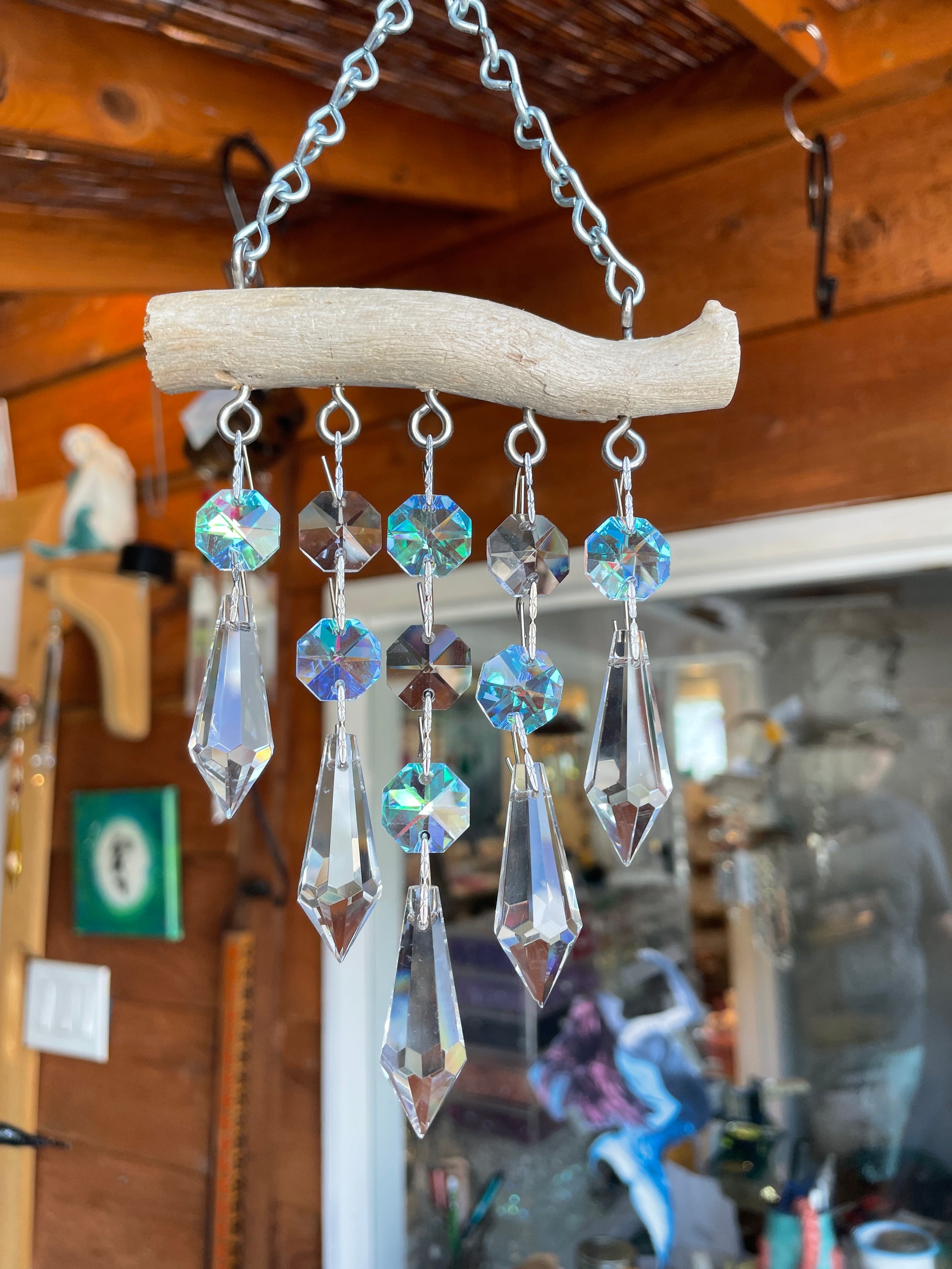 natural driftwood sun catching chandelier crystals clear and aurora borealis